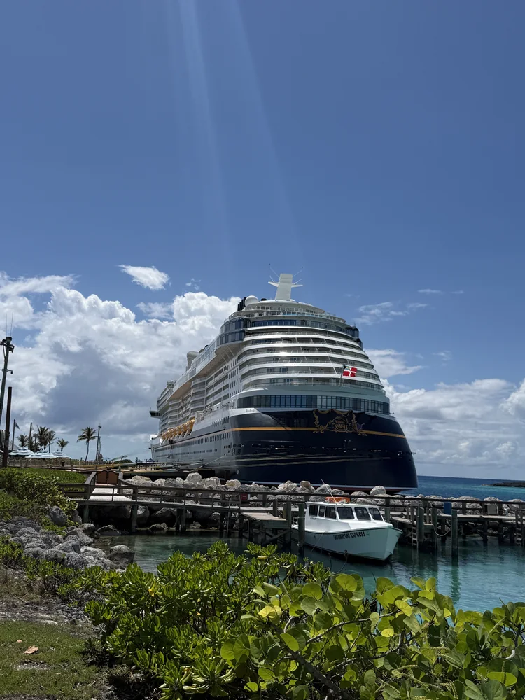 Disney Cruise Line ship docked near blue water